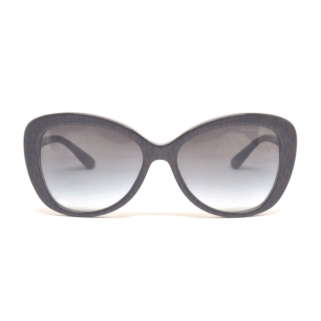 MICHAEL KORS MK 2120 POSITANO col. 33558G è un occhiale da sole in acetato marrone scuro con logo "mk" jacqaurd e calibro 56.